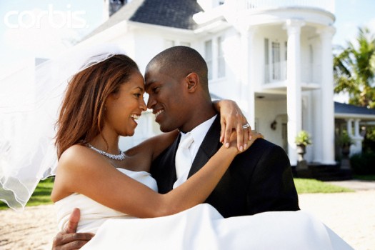 Happy Newlyweds in Front of Mansion --- Image by © Greg Hinsdale/Corbis